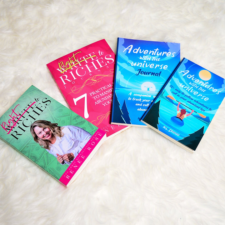 Write To Riches book and workbook plus Adventures with the universe book and workbook laid out on white blanket