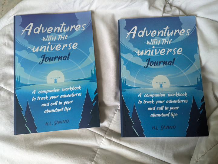 2 copies of the workbooks on white blanket