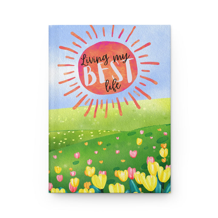 "Living my best life" in painted style orange sun like burst over blue sky with a meadow and tulips