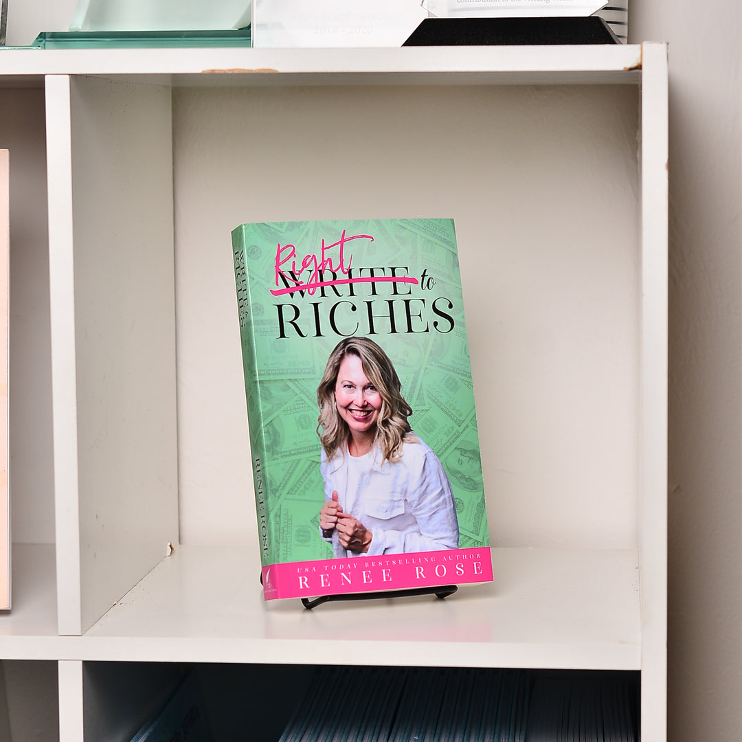 Book titled Write to Riches by Renee Rose on a shelf.